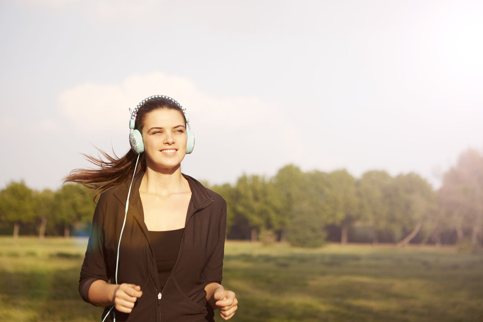 Woman running outdoors and smiling